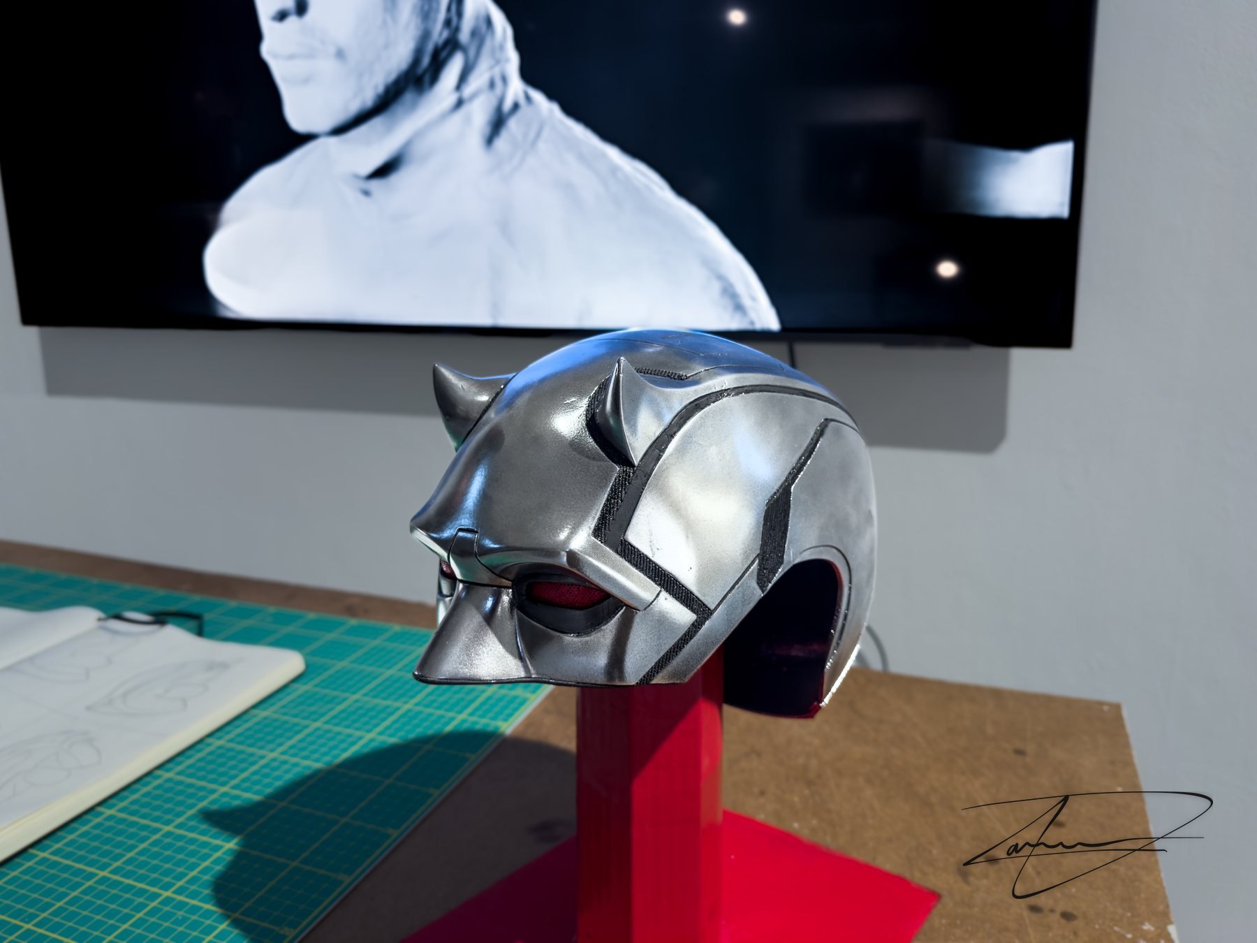 A replica Daredevil helmet, welded together from two failed prints and repainted in my own color scheme. The Netflix series was the reference for the eyepiece, and the replica was built to have the thing itself on the table next to the design it fed.