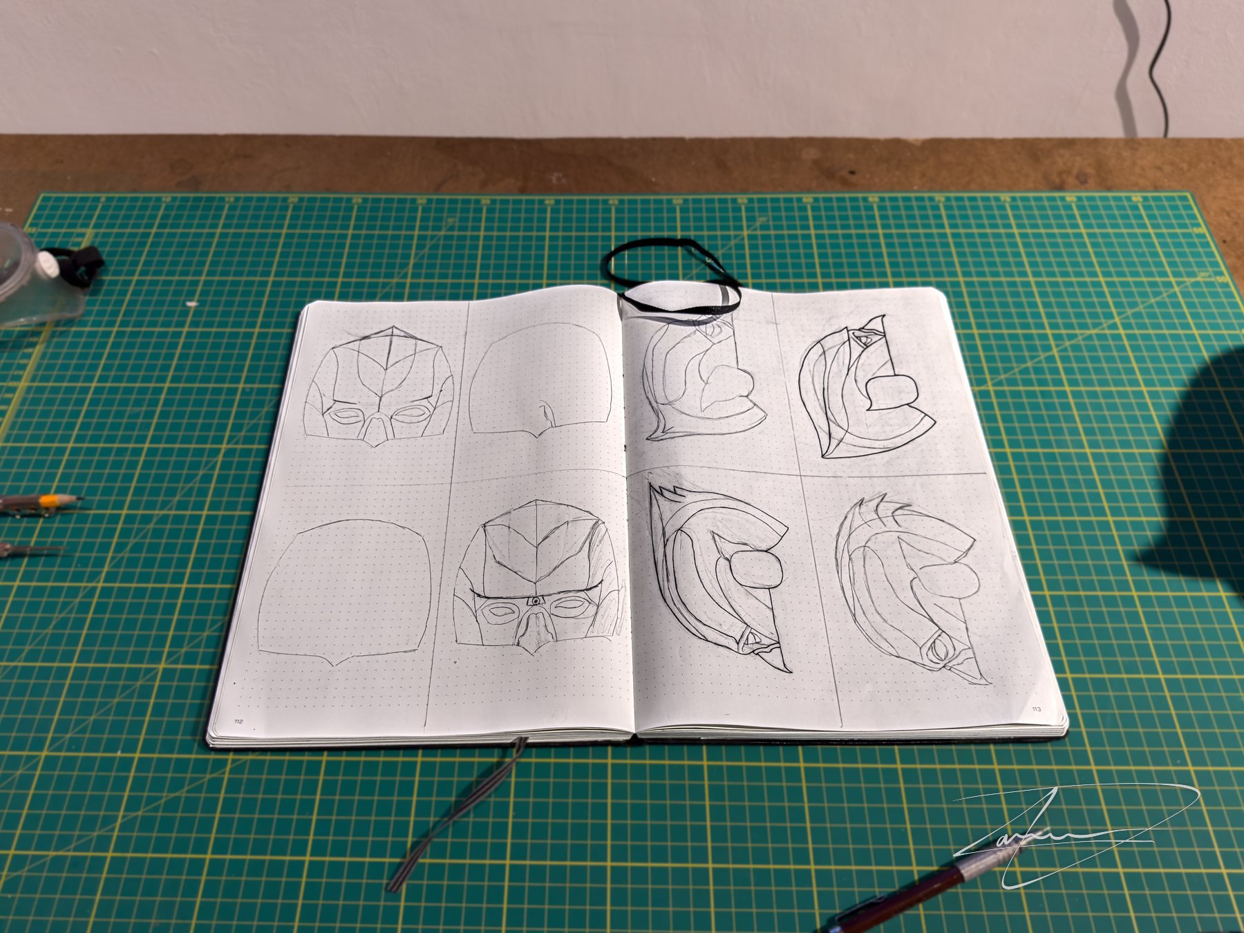 Sketchbook, kept open in the installation. The design began on paper, cycling through silhouettes and proportions before any of it went into Blender.